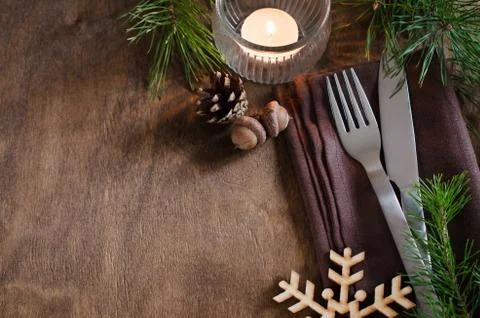 Rustic Christmas table setting with candle. Stock Photos