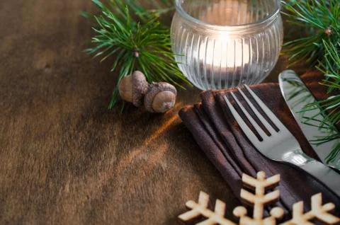Rustic Christmas table setting with candle. Stock Photos