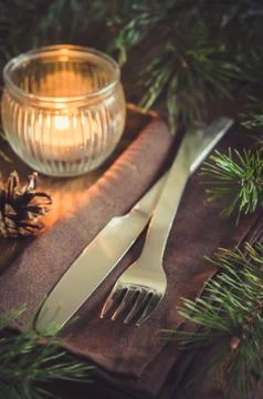 Rustic Christmas table setting with candle. Stock Photos