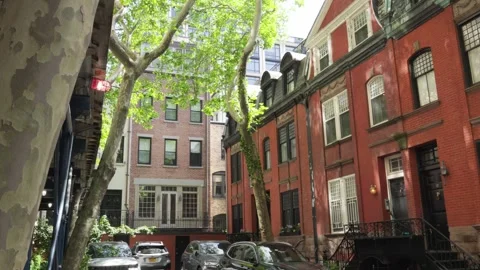 Rustic clasic red brick brownstone buidings line an alley in Manhattan with Stock Footage 242365984