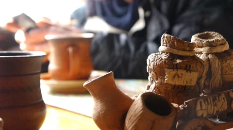 Rustic Clay Utensils In Cafe And A Man With Mobile Phone On The Blurred Backg Video stock 64732142