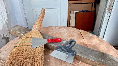 Rustic Cleaning Tools on an Old Wooden Table in a Weathered Interior Room Stock Footage 344756835