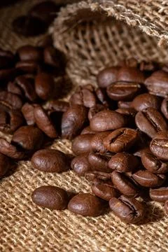 Rustic close-up of fresh coffee beans on a natural burlap background Stock Photos