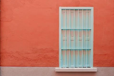 Rustic closed window with shutters on old building on the textured wall of .. Stock Photos