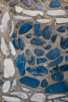 Rustic cobblestone path with blue and white stones forming natural mosaic p.. Stock Photos