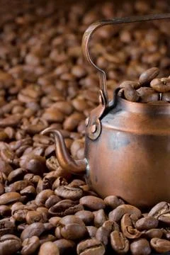 Rustic coffee pot with coffee beans Stock Photos