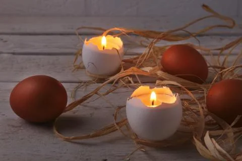 Rustic composition with candles and eggs. Happy easter. Selective focus. Stock Photos