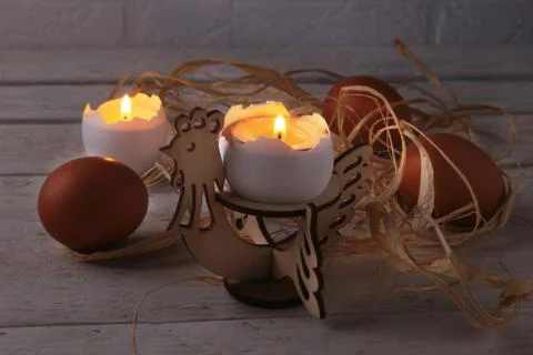 Rustic composition with candles and eggs. Happy easter. Selective focus. Stock Photos