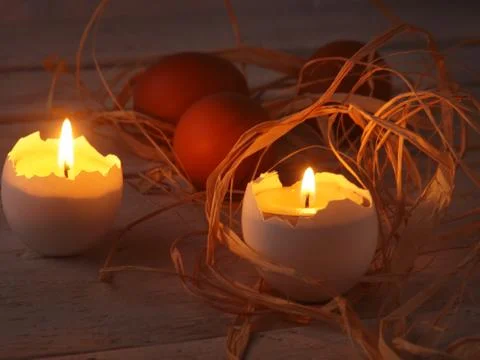 Rustic composition with candles and eggs. Happy easter. Selective focus. Stock Photos