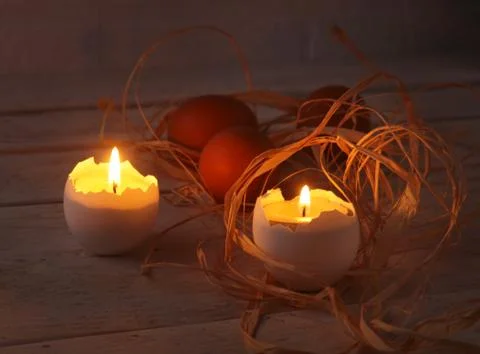 Rustic composition with candles and eggs. Happy easter. Selective focus. Stock Photos