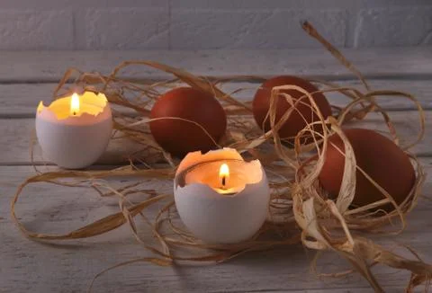 Rustic composition with candles and eggs. Happy easter. Selective focus. Stock Photos