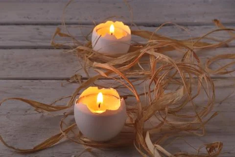 Rustic composition with candles and eggs. Happy easter. Selective focus. Stock Photos