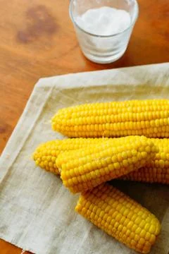 Rustic concept just cooked corn with salt on table Stock Photos