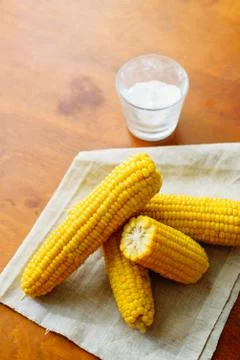 Rustic concept just cooked corn with salt on table Stock Photos