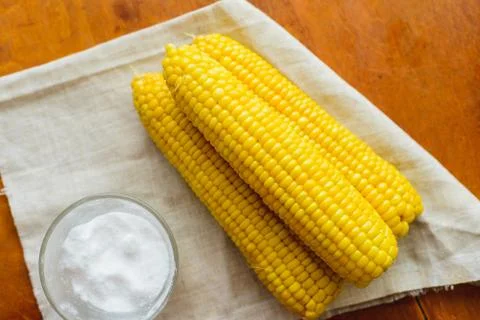 Rustic concept just cooked corn with salt on table Stock Photos