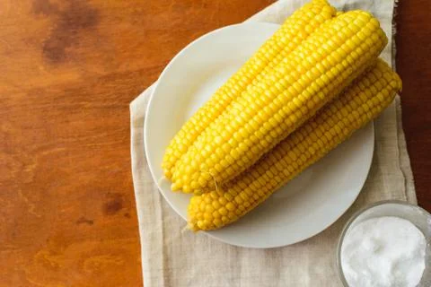 Rustic concept just cooked corn with salt on table Stock Photos