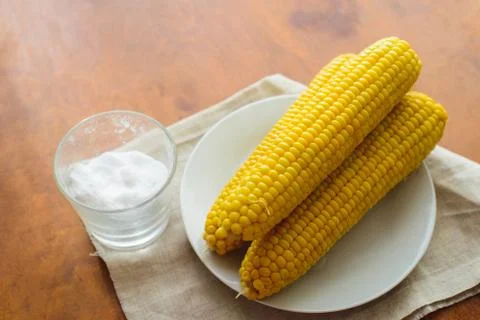 Rustic concept just cooked corn with salt on table Stock Photos
