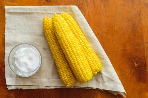 Rustic concept just cooked corn with salt on table Stock Photos