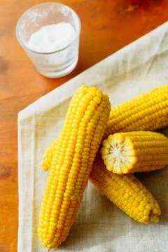 Rustic concept just cooked corn with salt on table Stock Photos