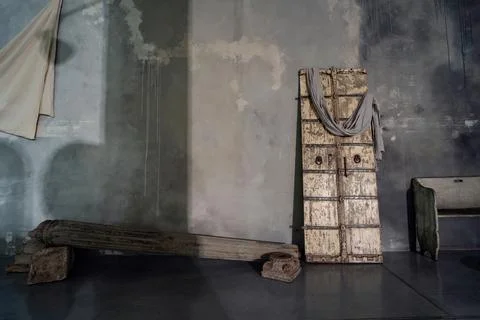 Rustic concrete designer interior with old wooden door, bench and column. Nat Stock Photos