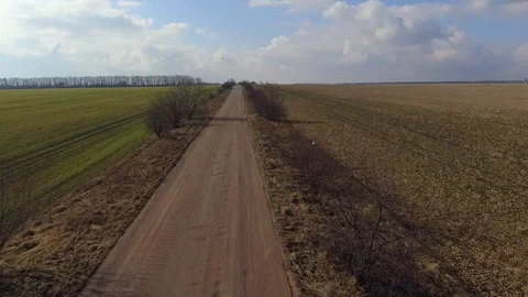 Rustic country landscape. Road in spring fields. Natural resources, environment Stock Footage 112089342