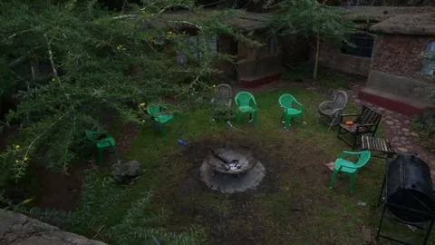 Rustic Courtyard With Fire Pit, Seating, and Traditional Mud Huts Video stock 309047881