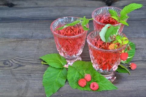 Rustic cuisine: red compote of raspberry. Tea raspberry with fresh raspberry Stock Photos