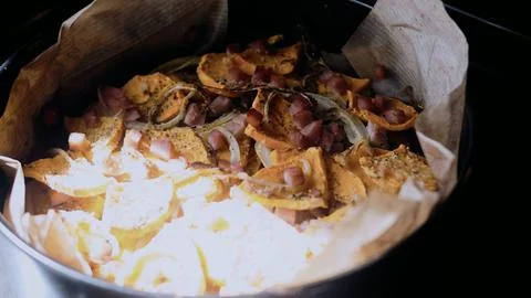 Rustic culinary close-up: arranging the mixture in a baking dish Stock Photos