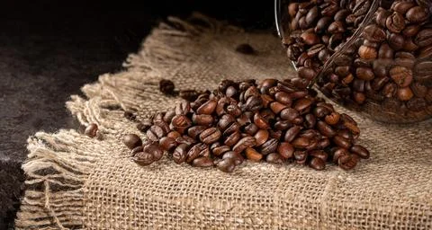 Rustic dark background with roasted coffee beans - low key artistic shot Stock Photos