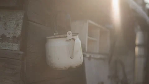 Rustic dawn kitchen. Retro kettle lit softly by early morning sun. Antique white Vidéo 346397655