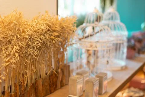 Rustic Decor with Dried Grass and Decorative Cages on Wooden Shelf Stock Photos