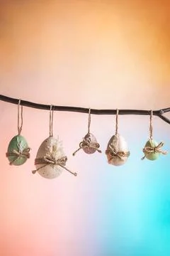 Rustic decorated eggs featuring pastel colors and natural twine, hanging from 스톡 사진