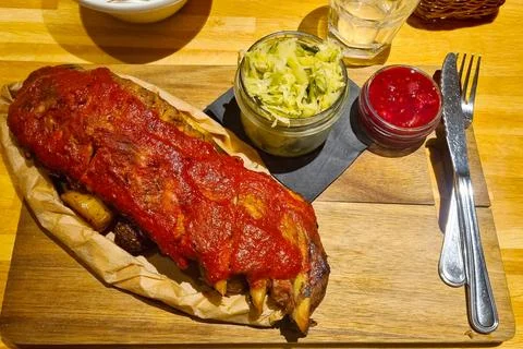 Rustic Dining Experience with BBQ Ribs and Cabbage Slaw on Wooden Board Stock Photos