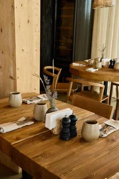 Rustic dining setup with ceramic cups and wooden tables 写真素材