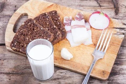 Rustic dinner on the board with milk, still life Stock Photos