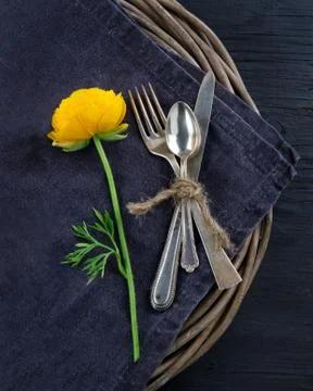 Rustic dinner setting with with a yellow flower Stock Photos