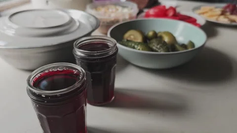 Rustic dinner table setup with various dishes, including pickled cucumbers Stock Footage 345601278