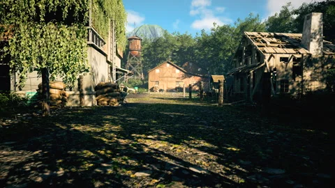 A rustic dirt road passes old buildings, trees, and a water tower Stockbeeldmateriaal 309071157