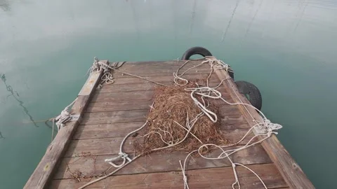 Rustic Dock With Nets and Reflections in Calm Marina Under Clouds Stock Footage 338106733