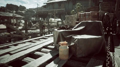 Rustic dockside setting with vintage crate, jug, and old wagon in the afternoon Stock Footage 321661976
