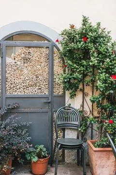 Rustic door filled with wine corks and garden chair Фото