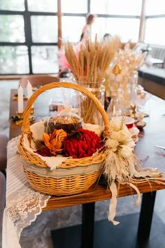 Rustic Easter craft table with wicker basket, dried flowers, and handmade Stock Photos