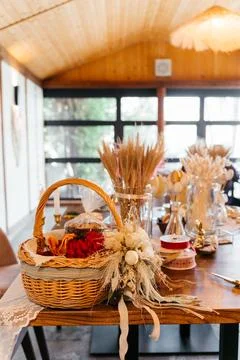 Rustic Easter craft table with wicker basket, dried flowers, and handmade Stock Photos