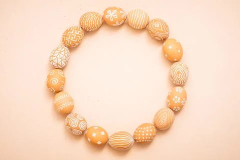 Rustic Easter eggs round frame on a clay texture. Copy space background Stock Photos