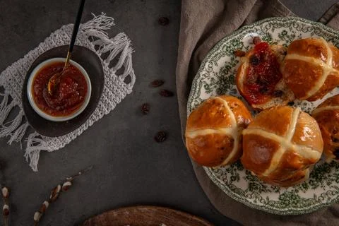 Rustic Easter Still Life with Glazed Hot Cross Buns and Fruit Jam Stock Photos