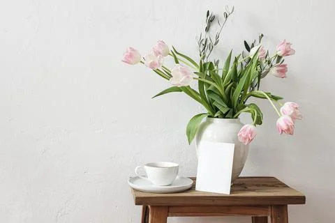 Rustic Easter still life scene. Blank greeting card mockup, cup of coffee and Fotos Stock