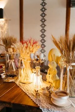 Rustic Easter-themed craft table decorated with dried flowers, wheat, and Stock Photos
