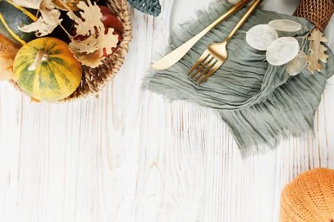 Rustic Fall Table Scene with Basket and Gold Cutlery Stock Photos