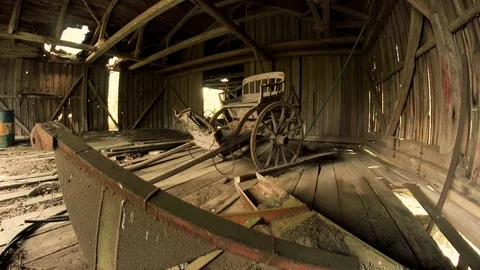 Rustic Farm Equipment in Abandoned Barn Stock Footage 107992448