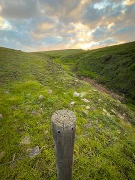 Rustic Farm Fence With Green Fields Stock Photos